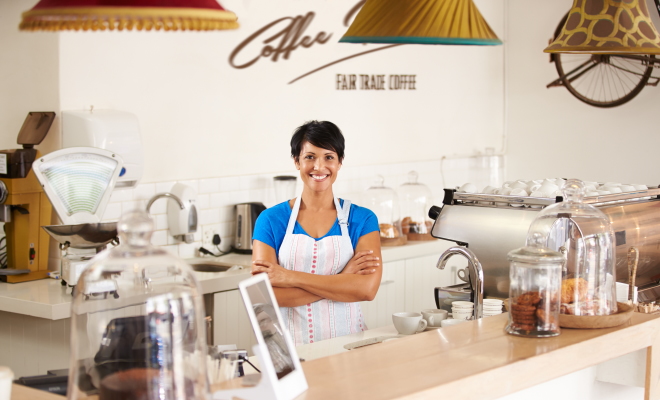 worker at a coffee shop smiling